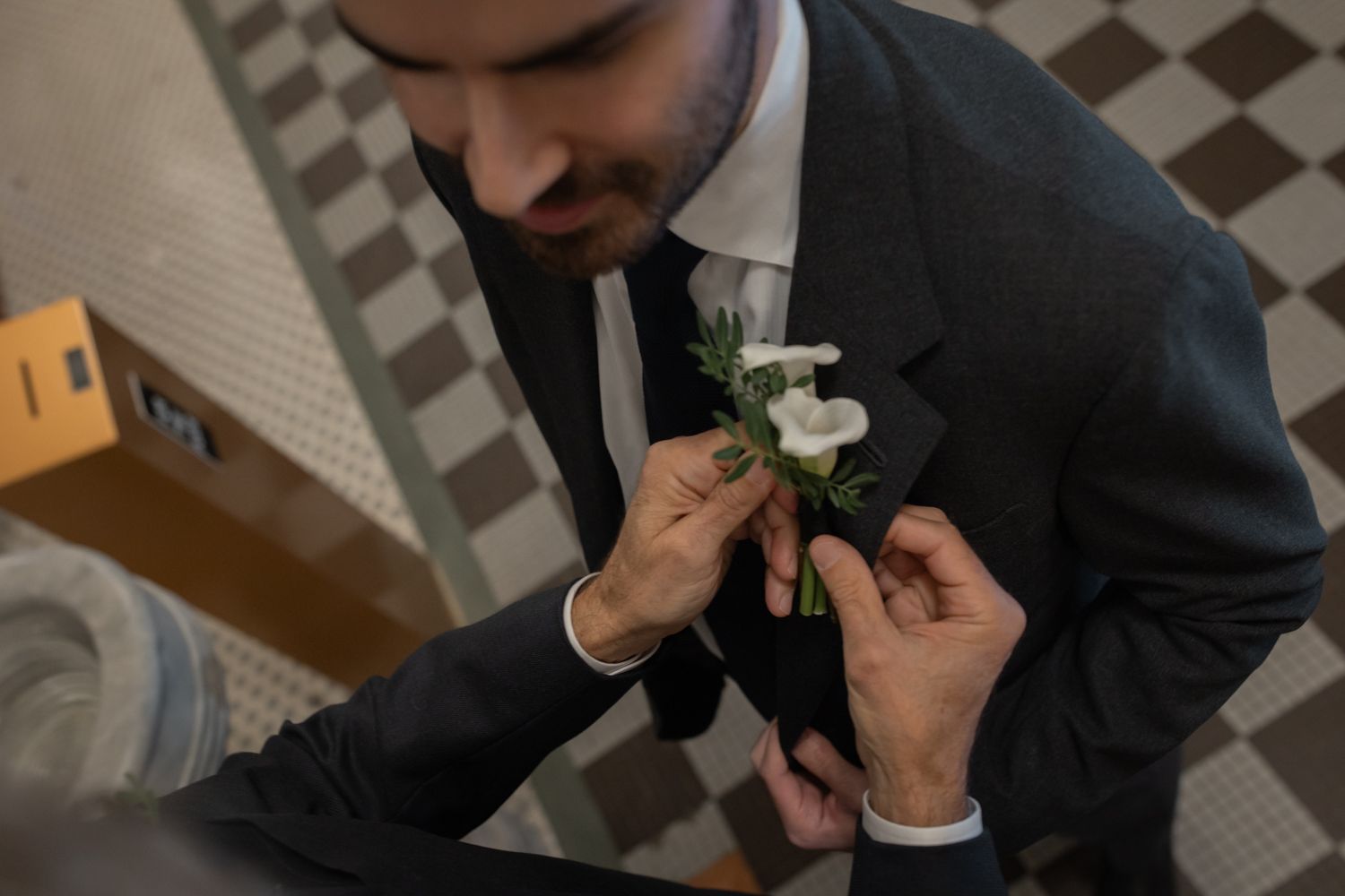 groom pinning corsage