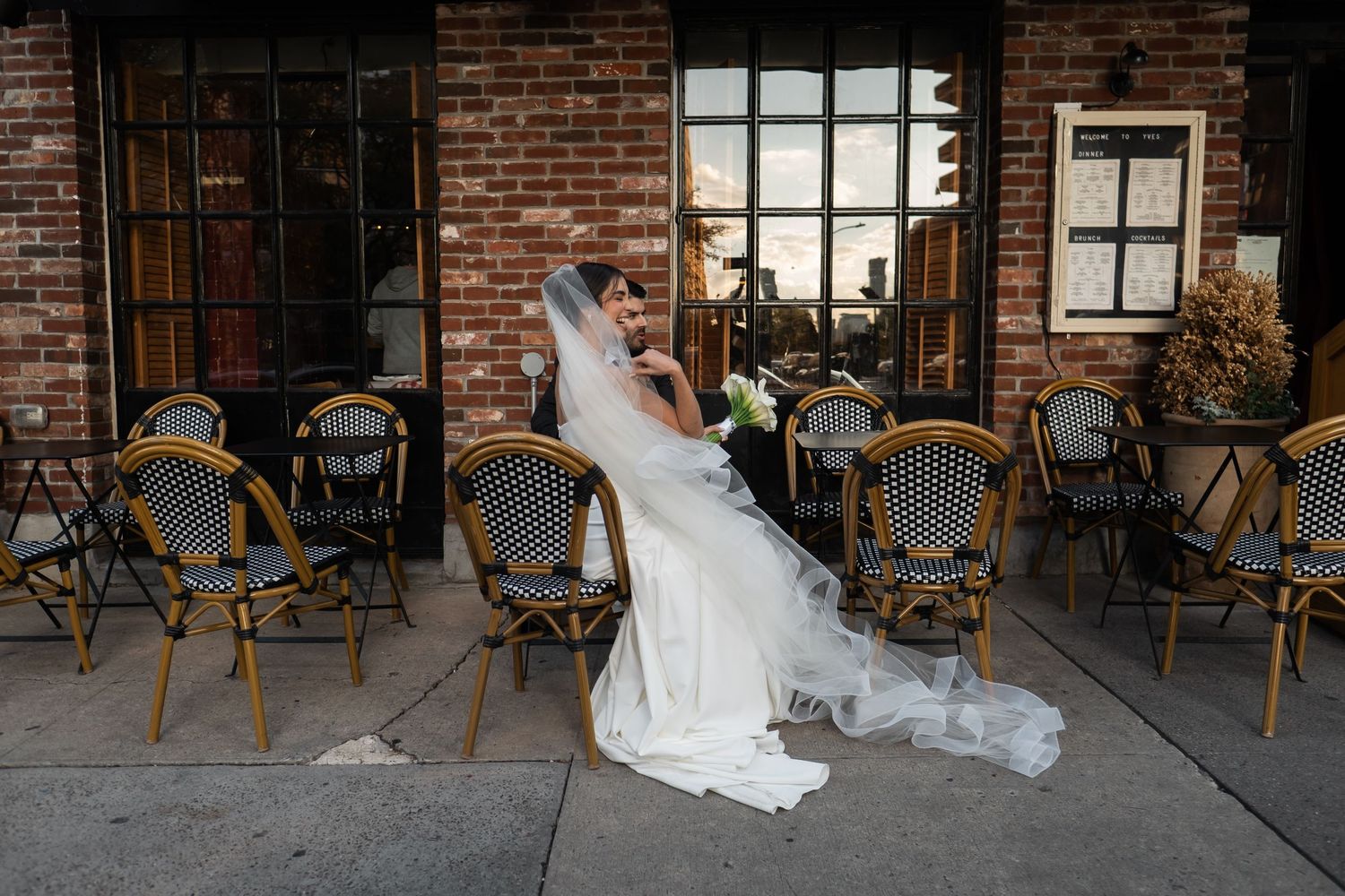 bride with long veil at cafe in new york