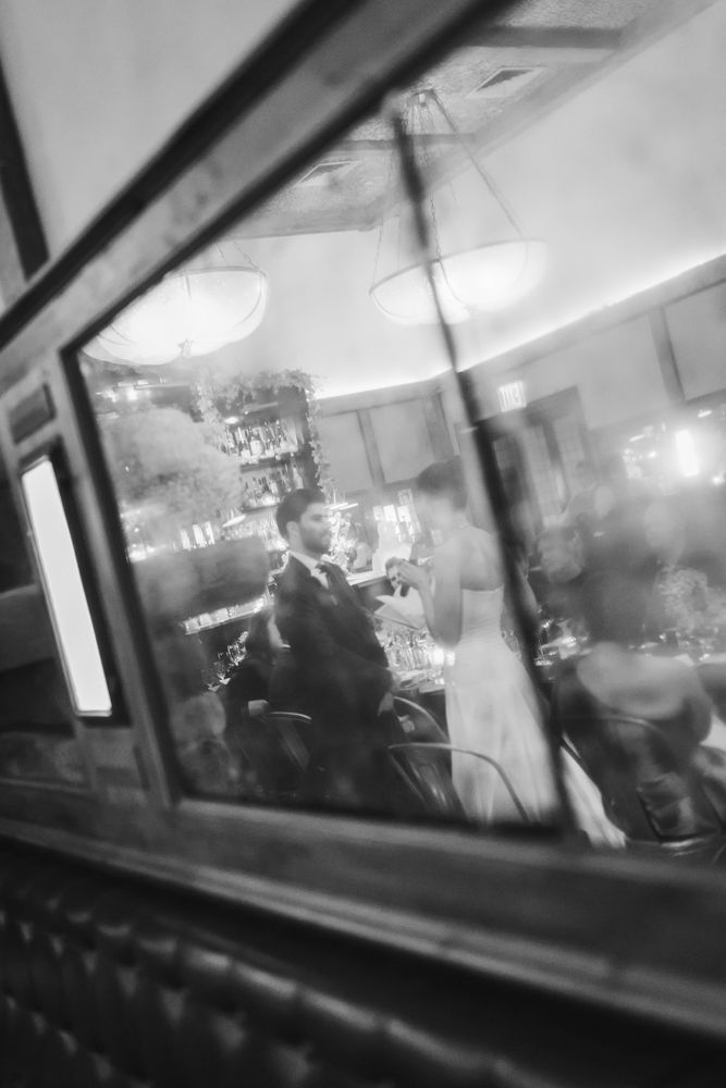 reflection of bride and groom exchanging vows at restaurant