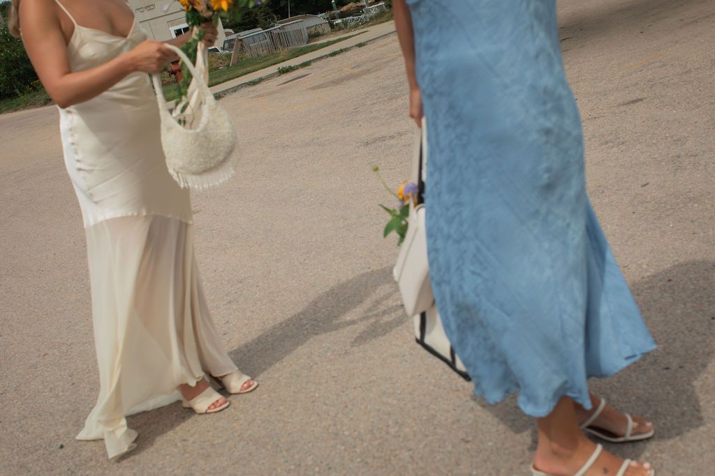 two women walk in flowing dresses