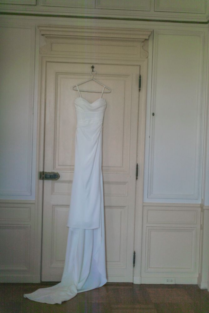 wedding dress hanging on door in french chateau
