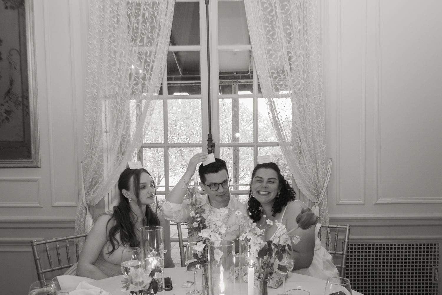 wedding guests laughing at reception tables
