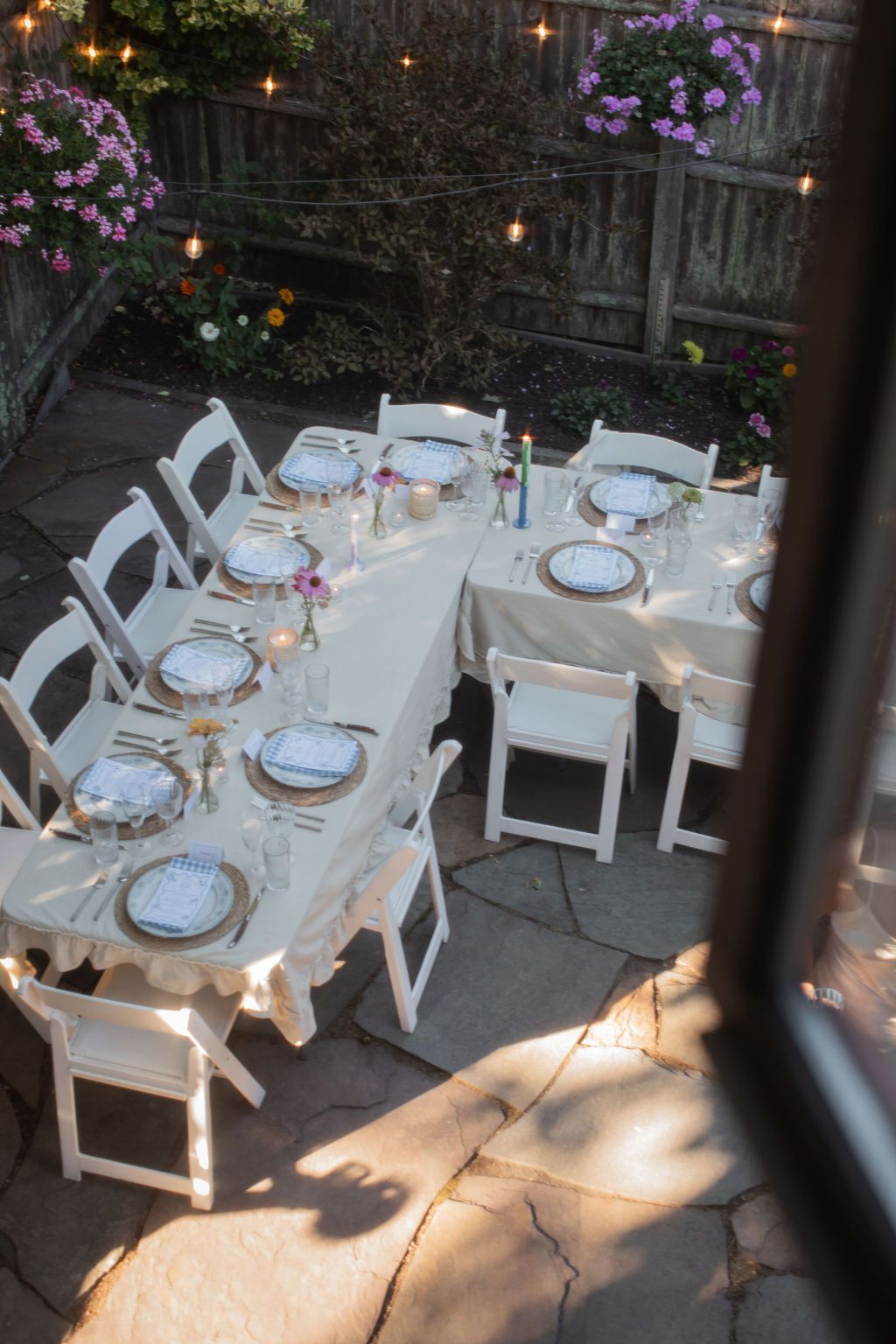 Elegant outdoor table settings with white linens and string lights create a romantic garden dining atmosphere in newport, rhode island