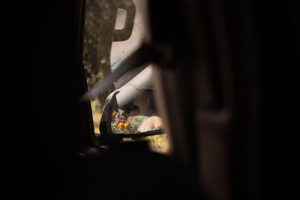 reflection of bride in side mirror