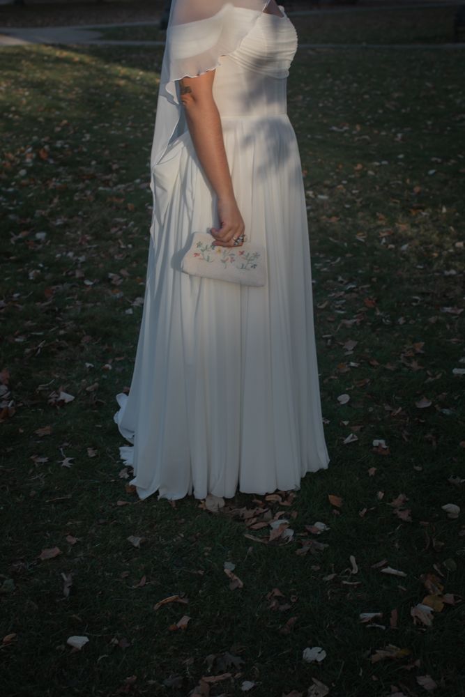 A flowing white dress captured in an outdoor garden setting at dusk