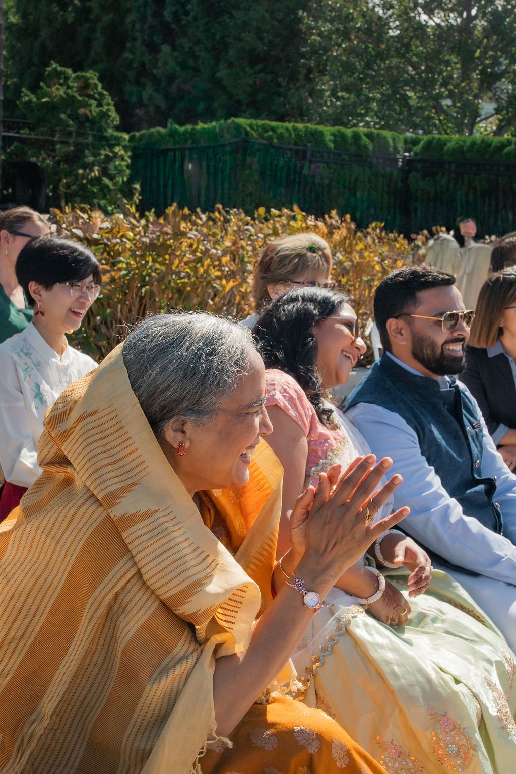 woman reacts joyfully in yellow sari