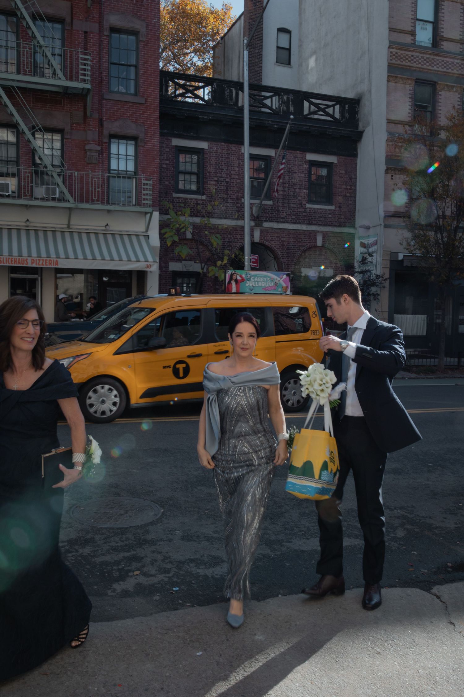 mother of the bride walks across the street in NYC