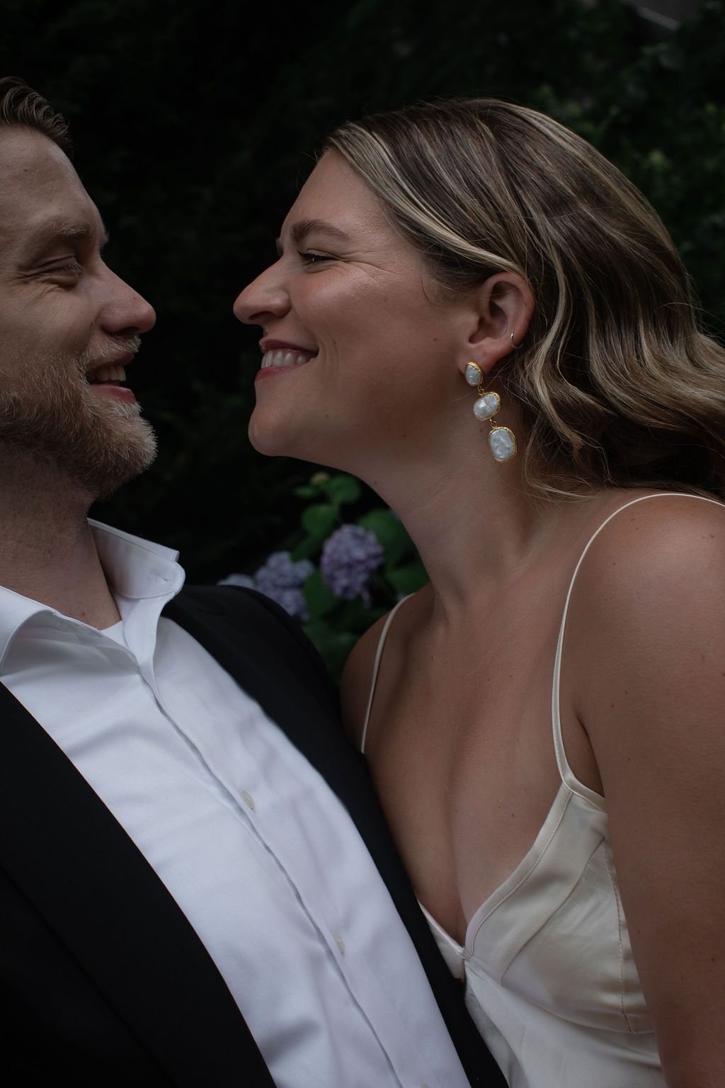 bride and groom facing each other smiling