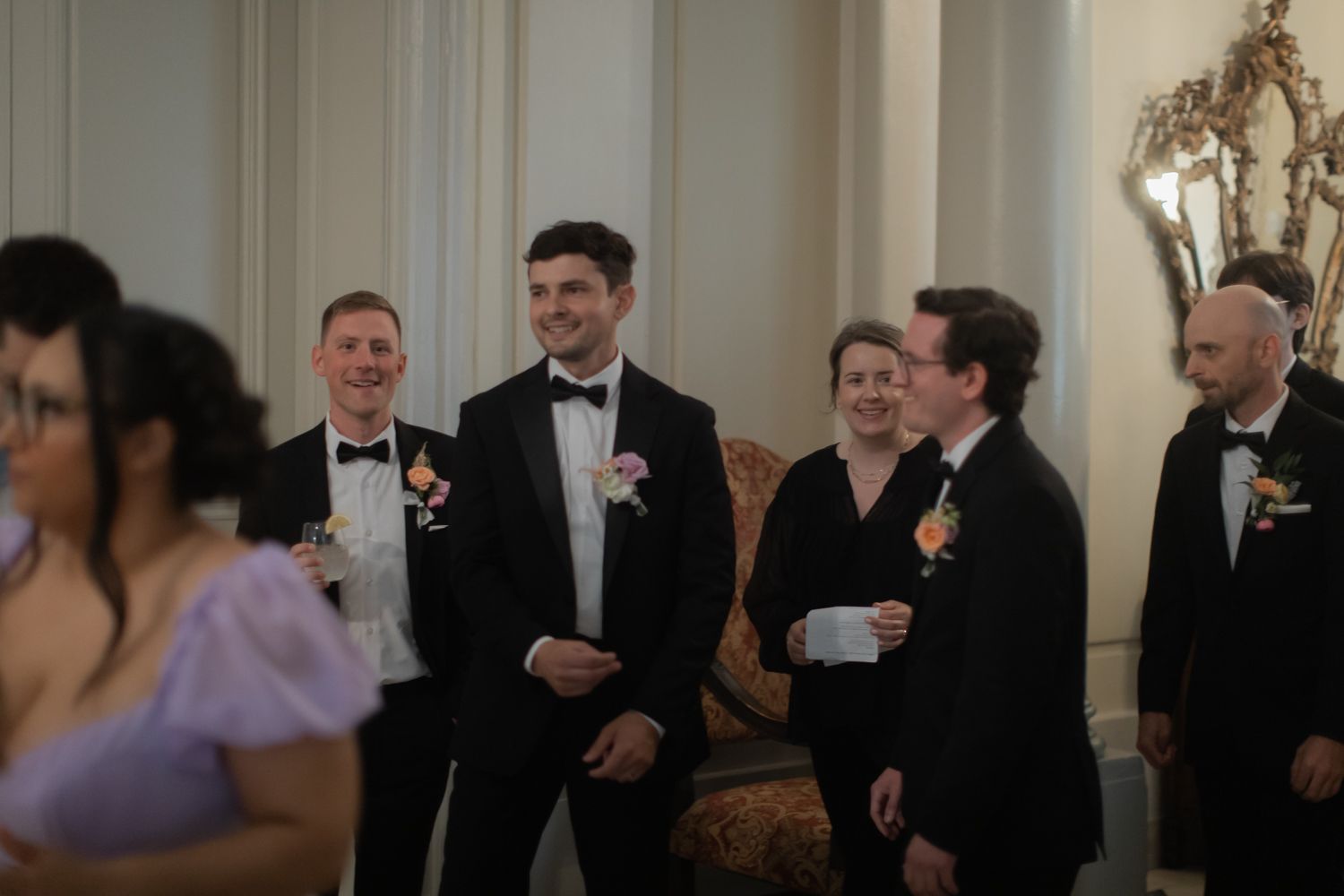 candid picture of groom smiling amidst guests