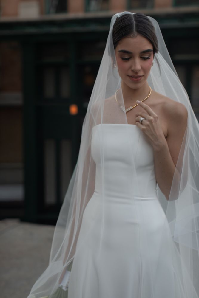image of bride holding necklace
