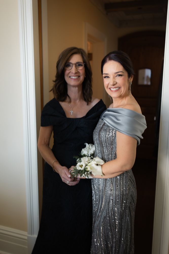 mother of the bride and groom posing for a picture
