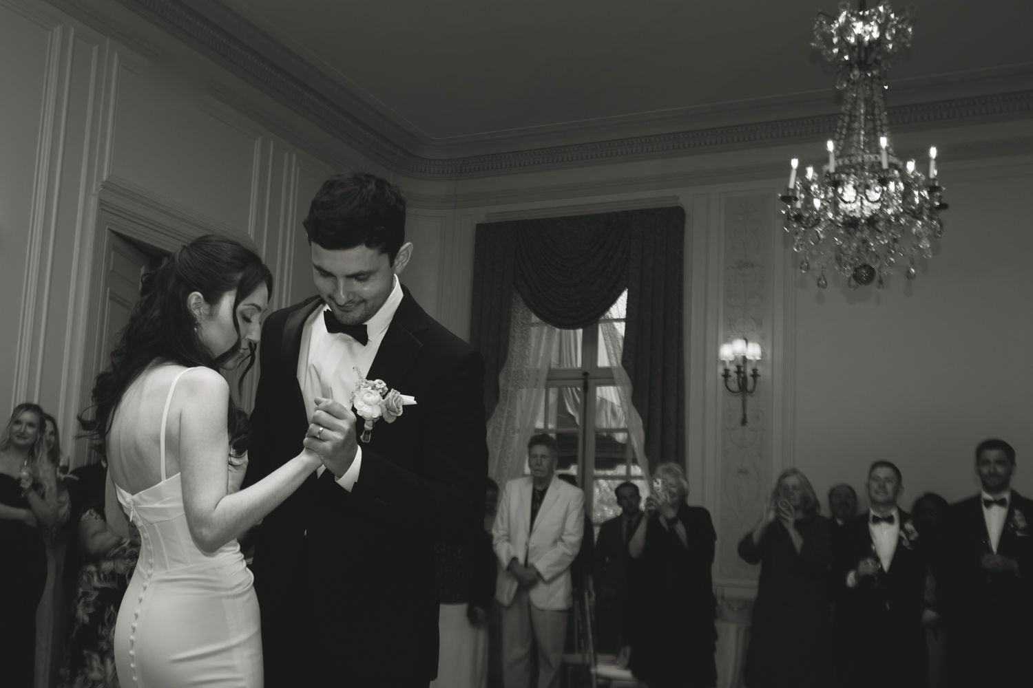 black and white photo of bride and groom sharing first dance
