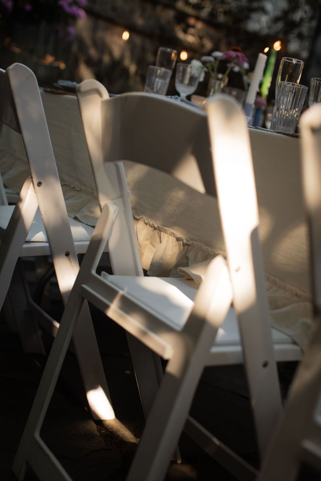 light on wedding garden chairs at backyard ceremony