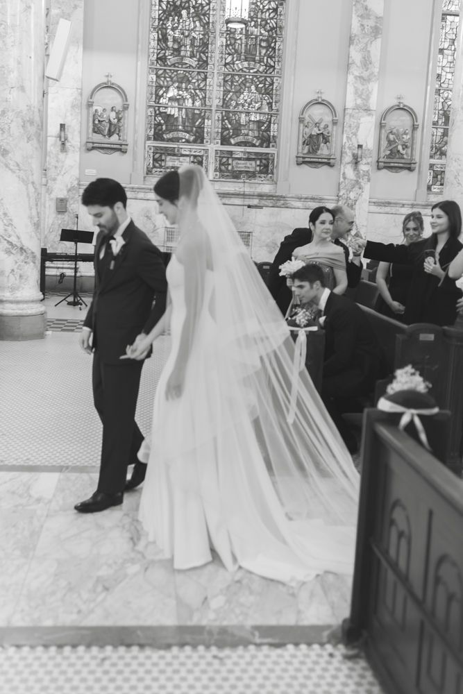 black and white photo of bride and groom at church