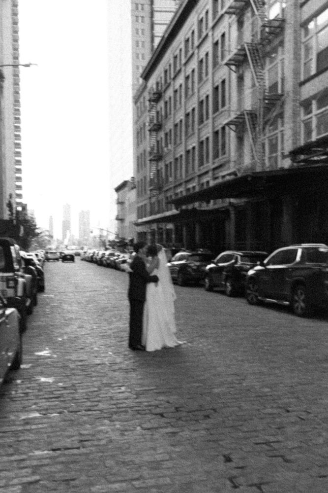 bride and groom kissing in streets of new york