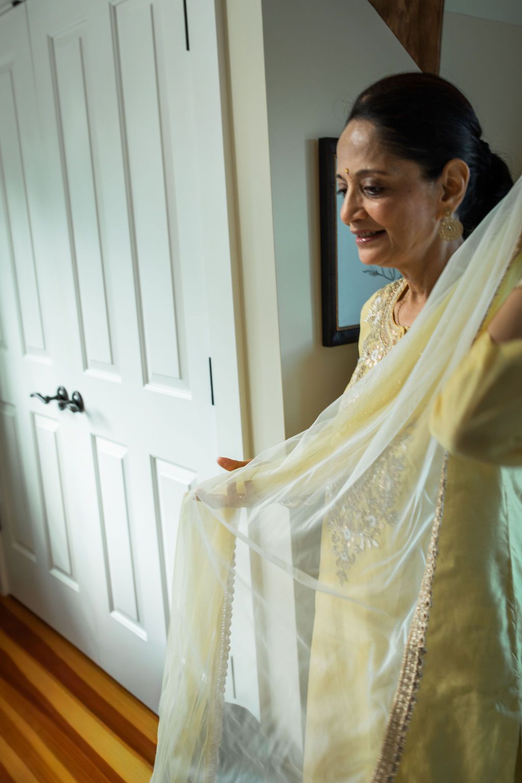 woman holding sheer yellow scarf