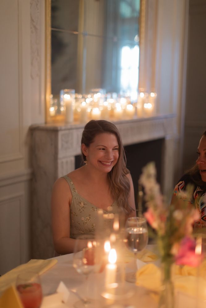 guest laughing at candlelit table wedding reception