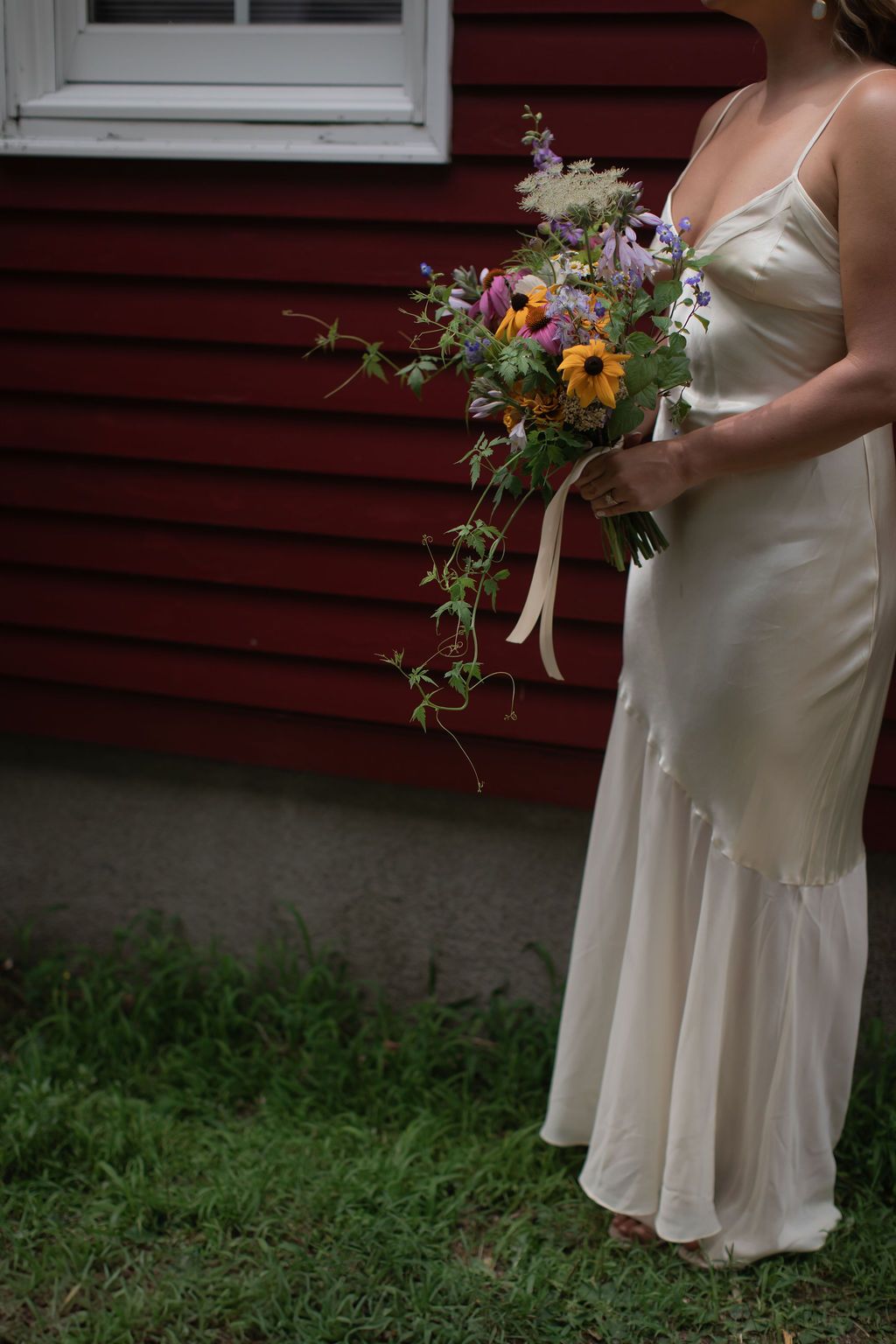 minimalist ivory wedding dress with wildflower bouquet