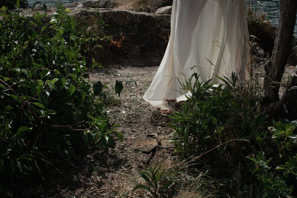 photo of flowy wedding dress near greenery