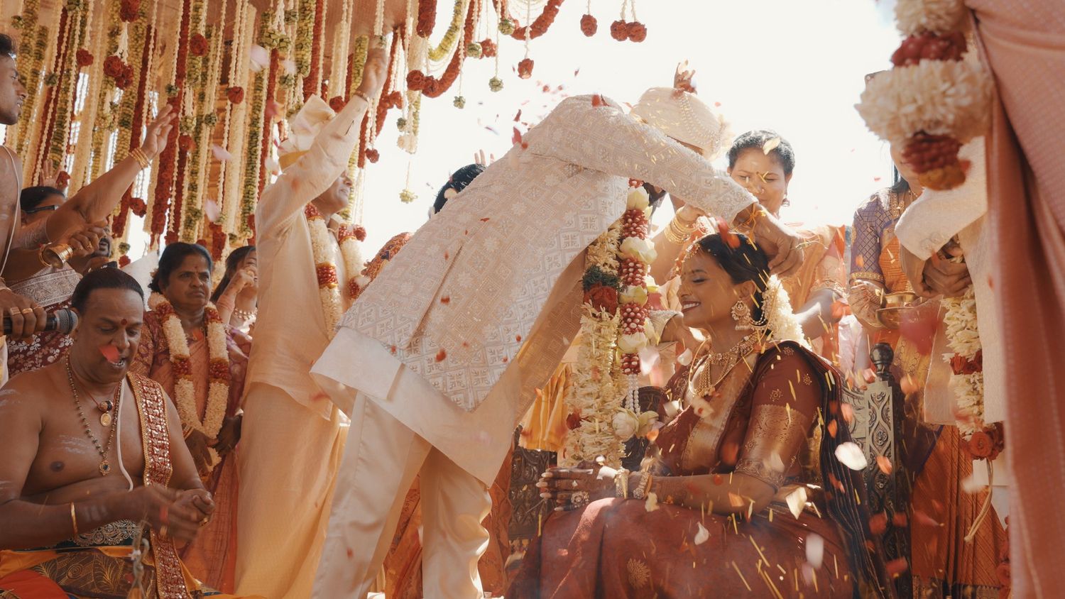 Festive celebration scene with rose gold decorations and confetti.