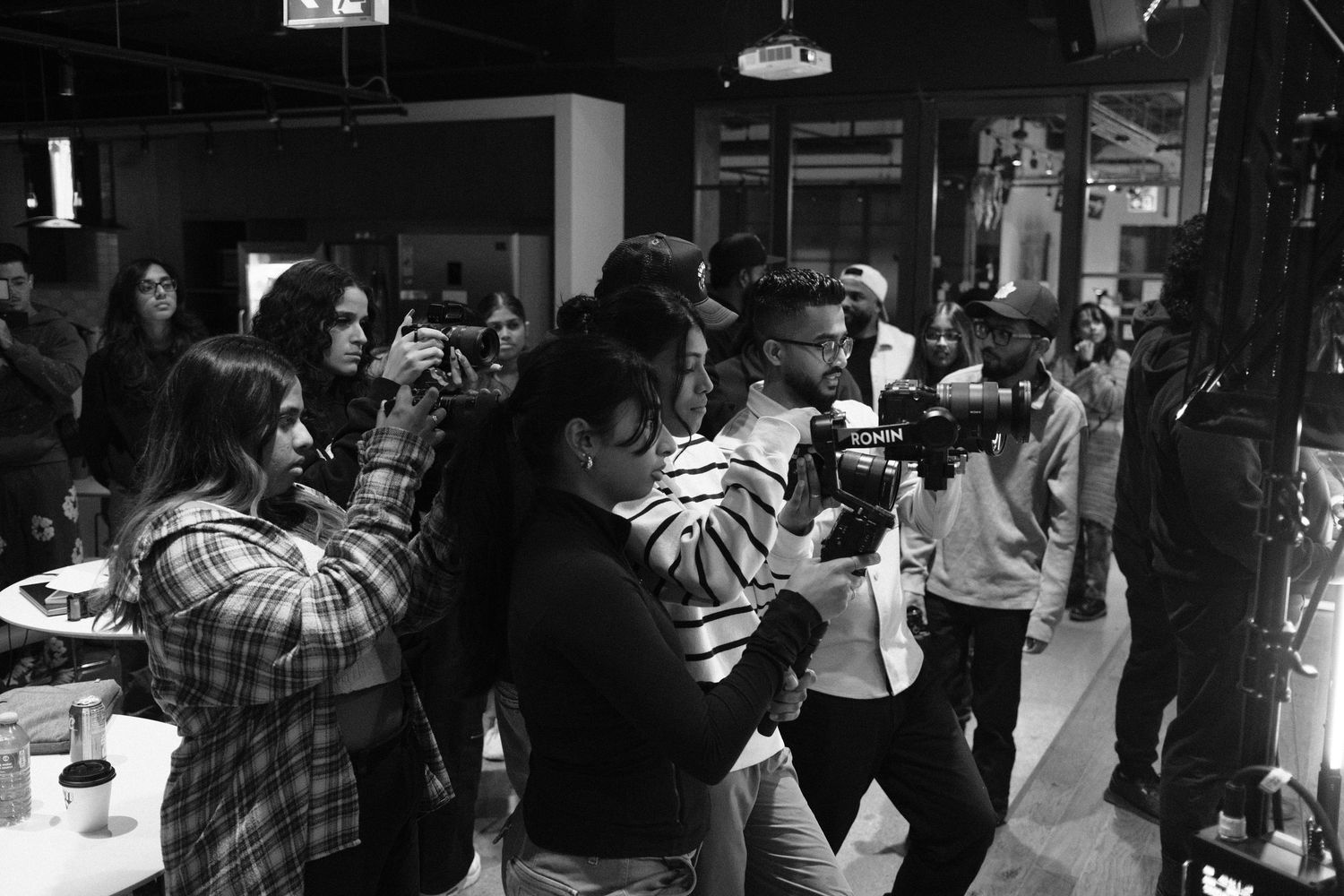 Panoramic view of networking event attendees in a dimly lit venue.