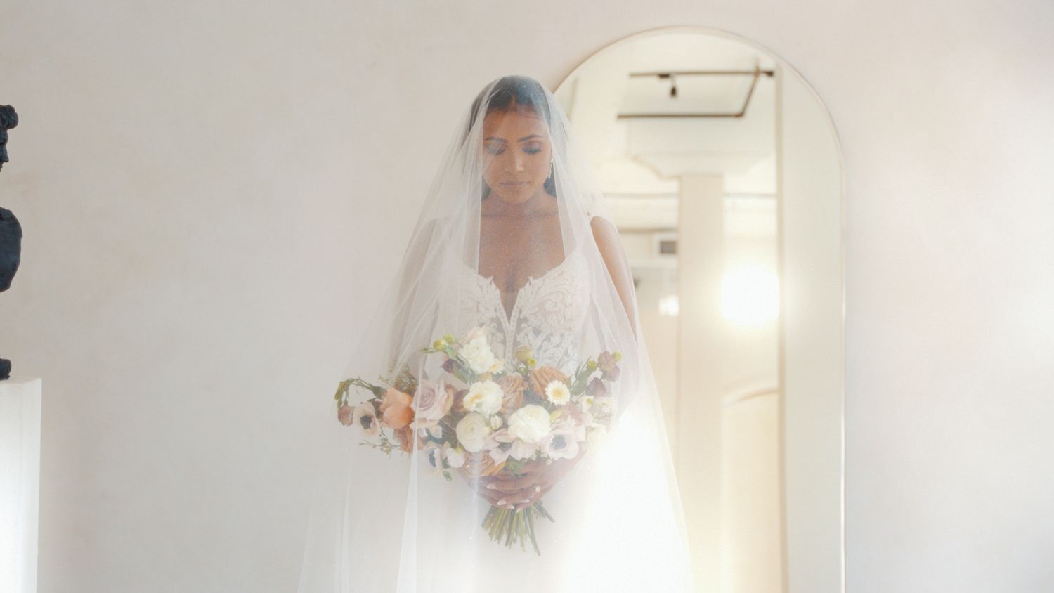 A bright, minimalist bridal preparation room with classical architectural details.