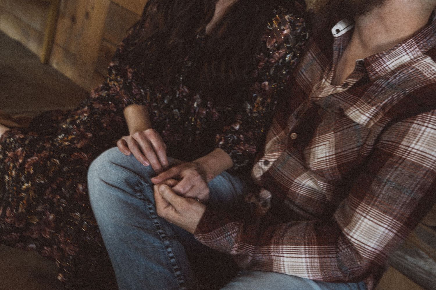 Intimate couple sharing tender moments in a cozy indoor setting with natural lighting.