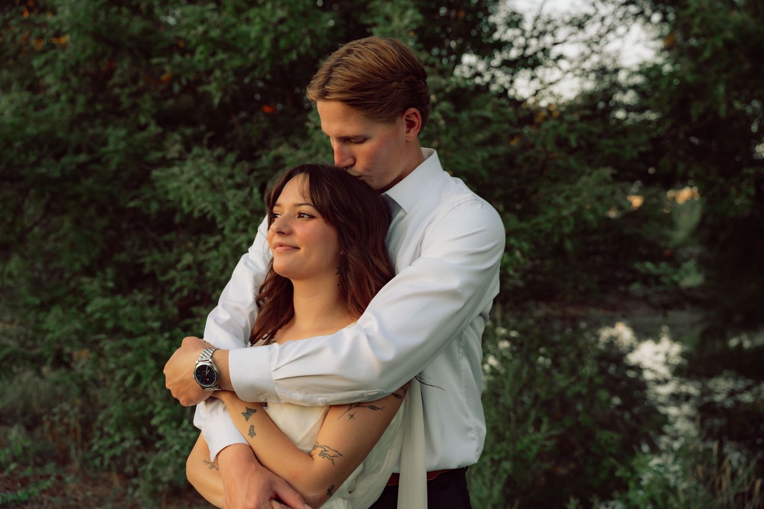 An intimate moment between newlyweds during their outdoor wedding photoshoot.