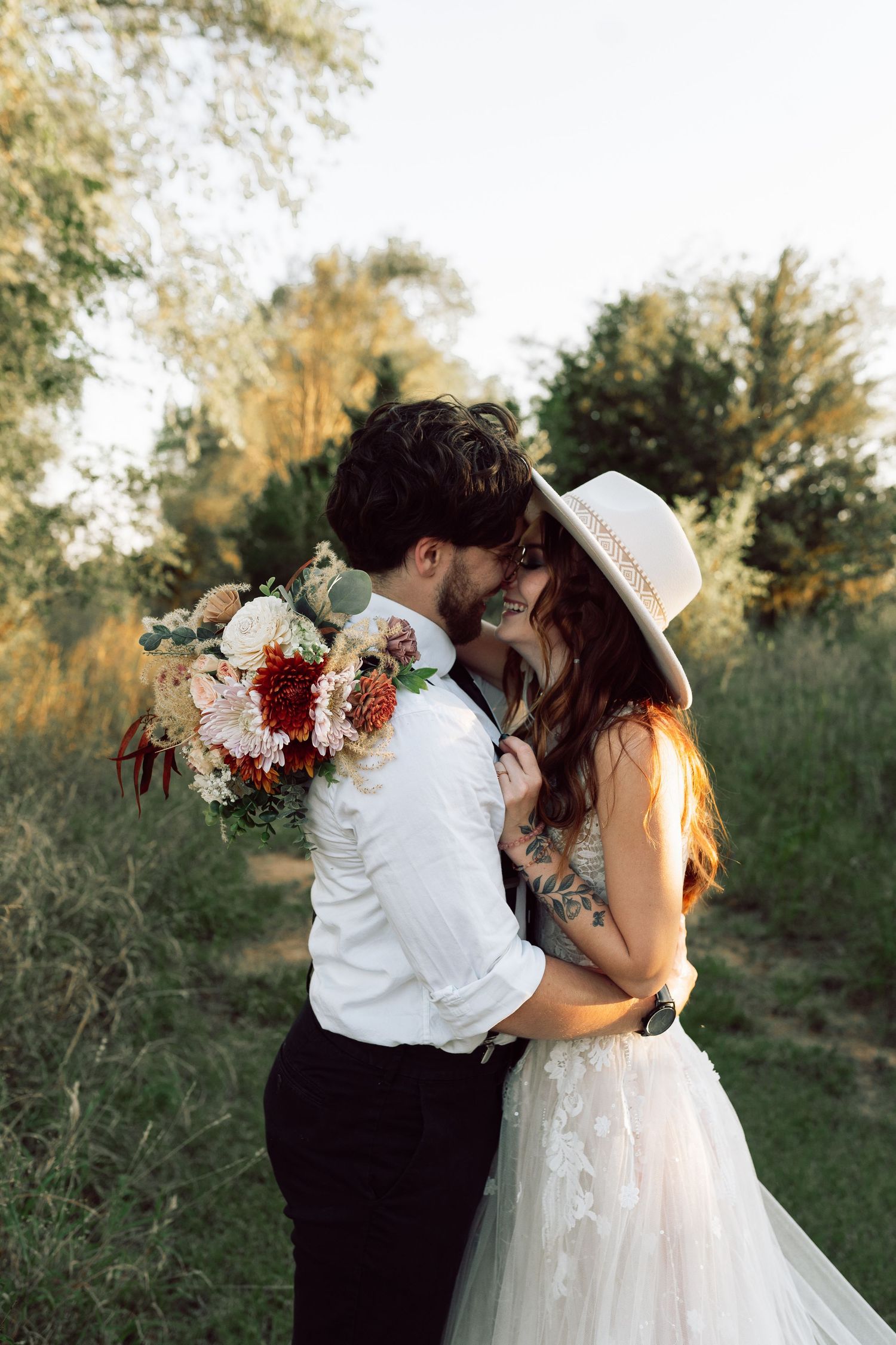 An intimate wedding portrait with delicate floral bouquet details.