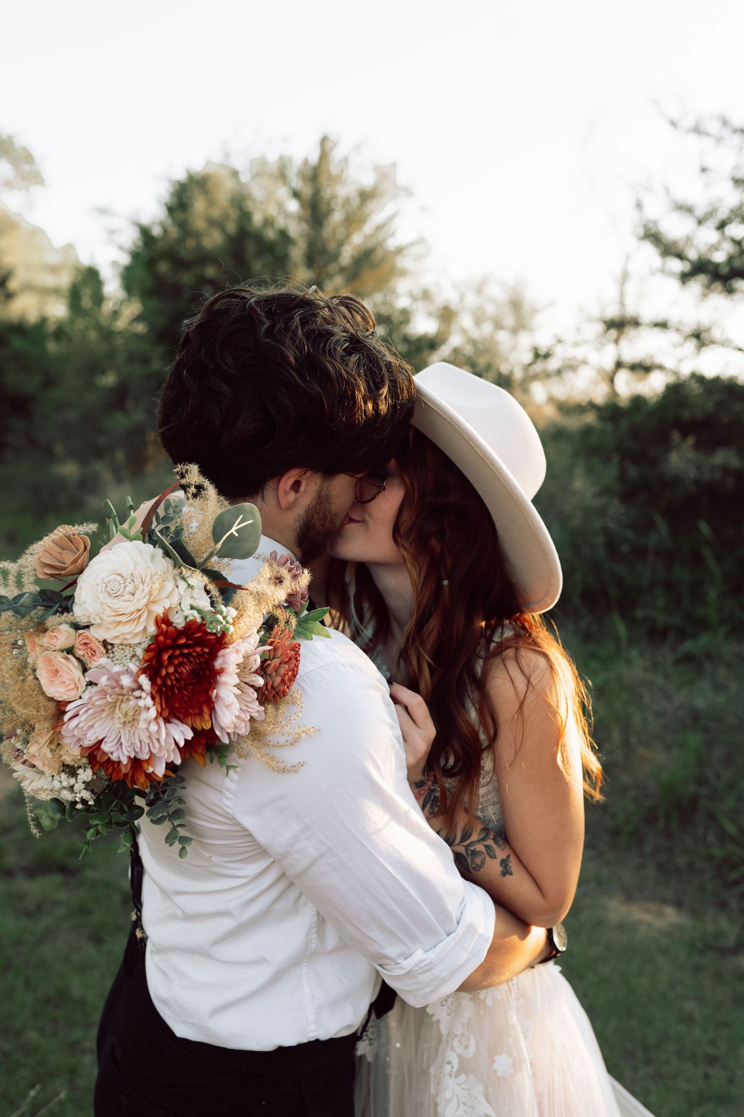 A candid wedding moment captured during golden hour with floral decorations.