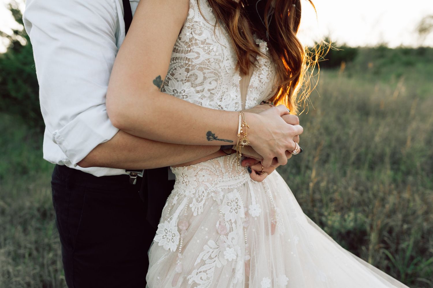 Detail shot of lace wedding dress with intricate beading in natural light.