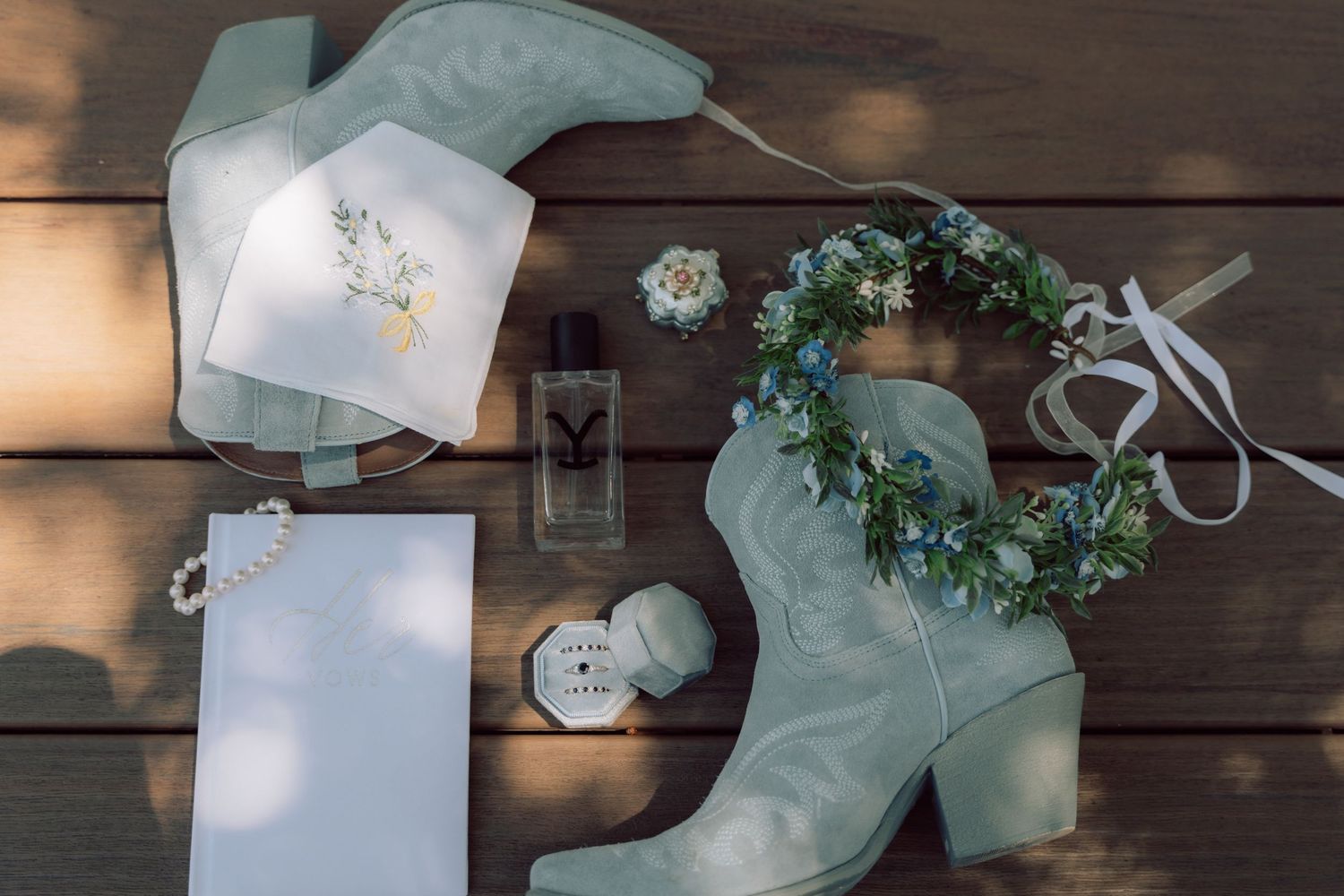 Wedding accessories including decorated face masks and floral elements on wooden deck.