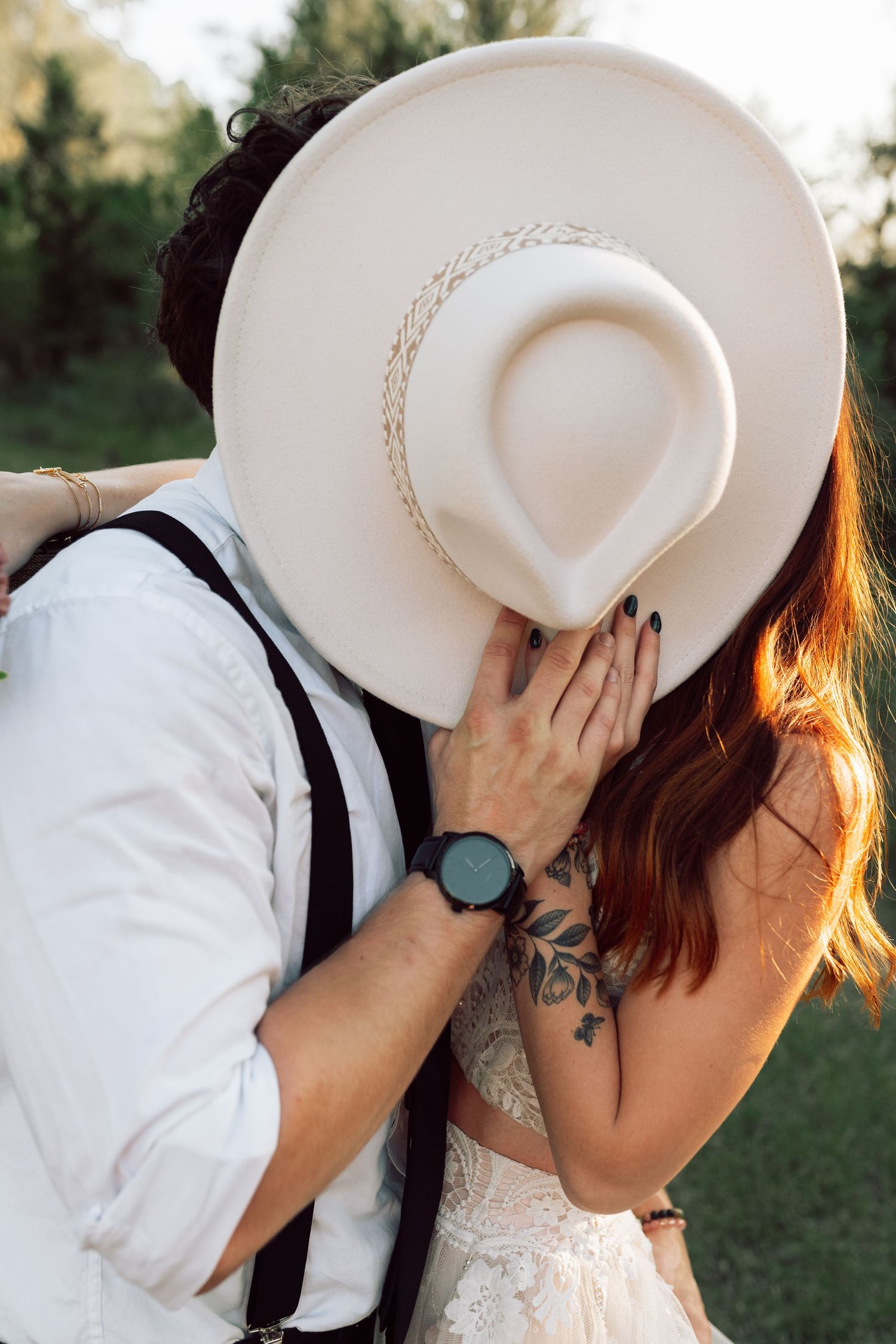 A creative wedding photo using a white dinner plate to frame an intimate moment.