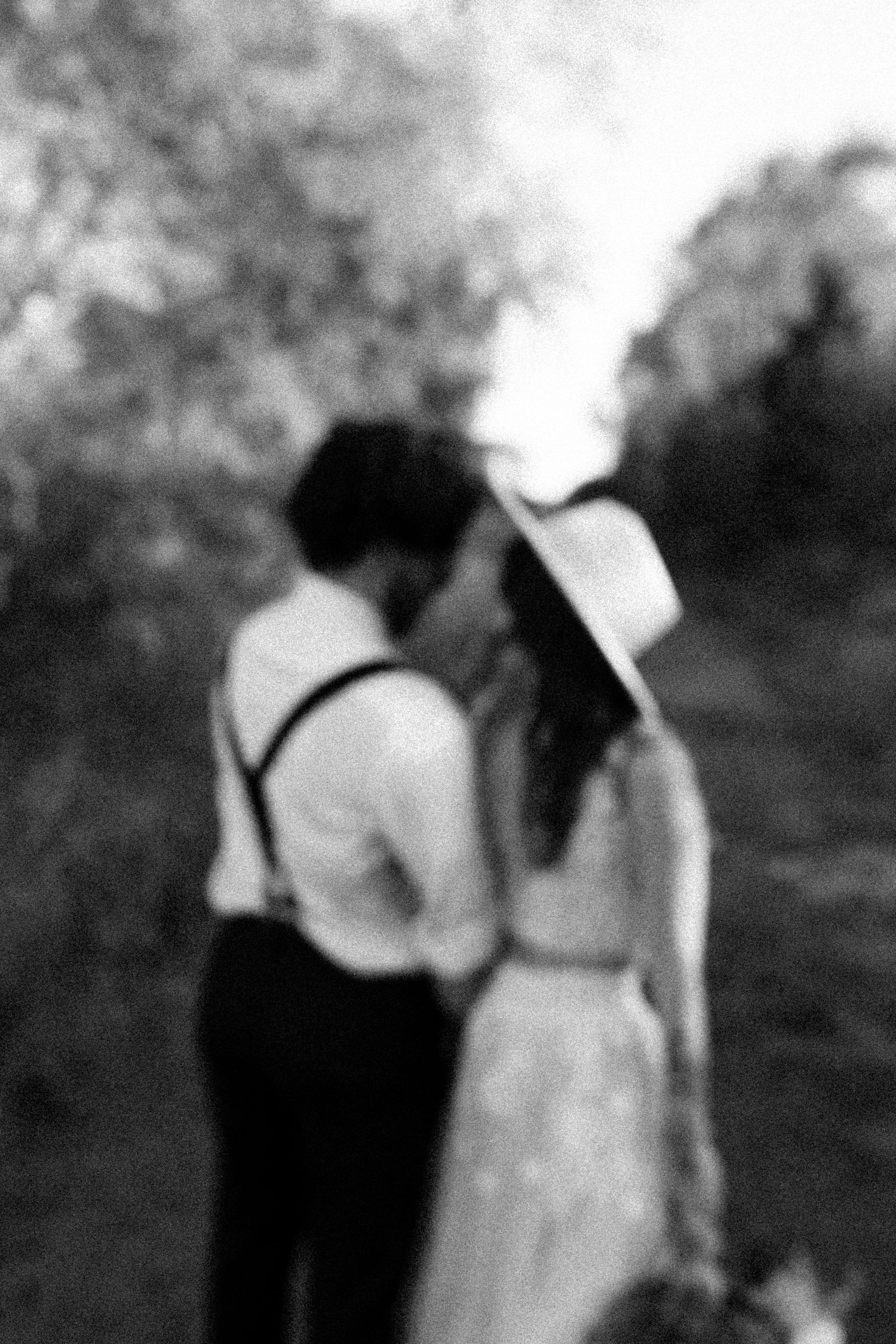 Black and white photo of a couple sharing an intimate moment during their wedding photoshoot.