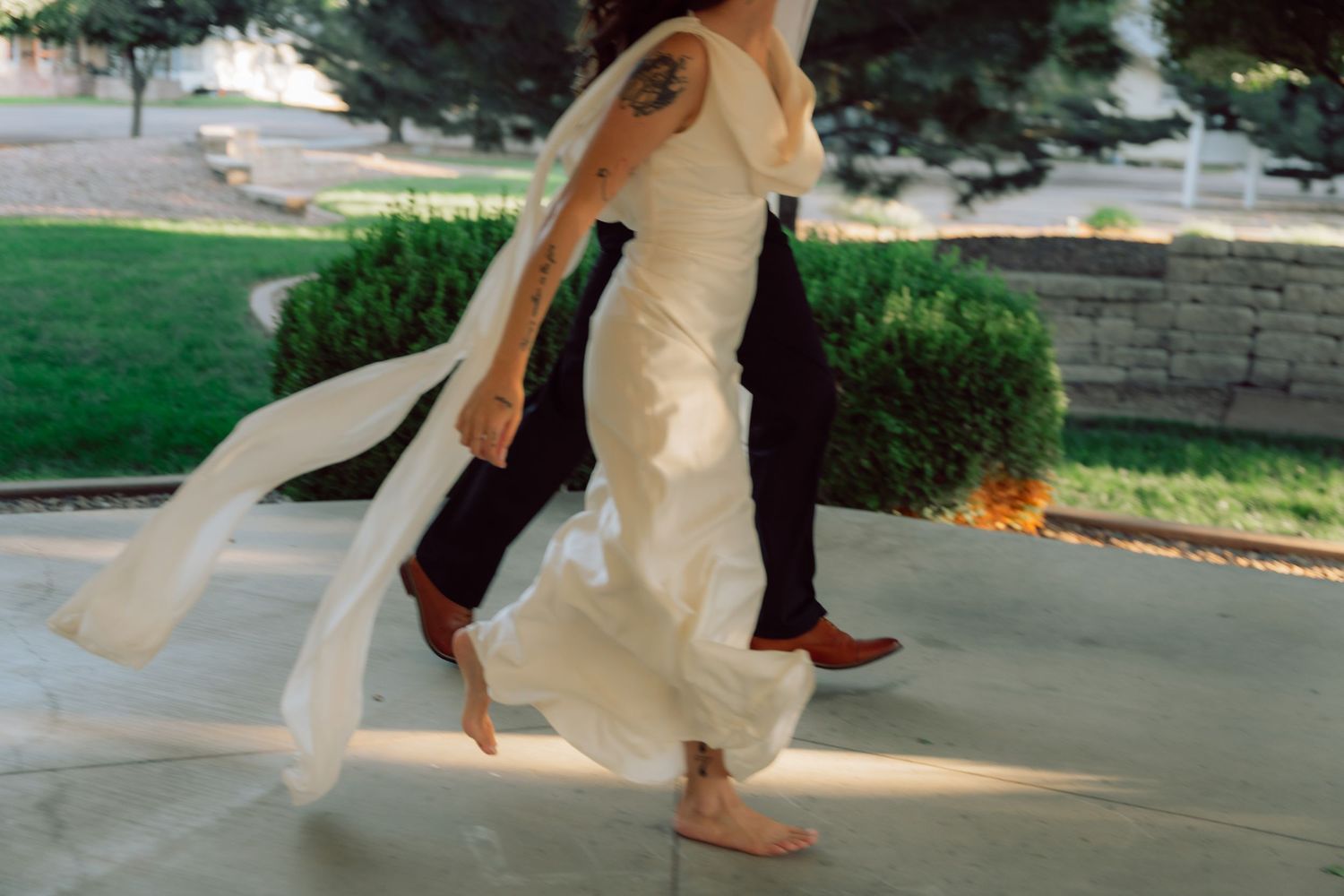 Flowing wedding dress movement captured during outdoor dance.