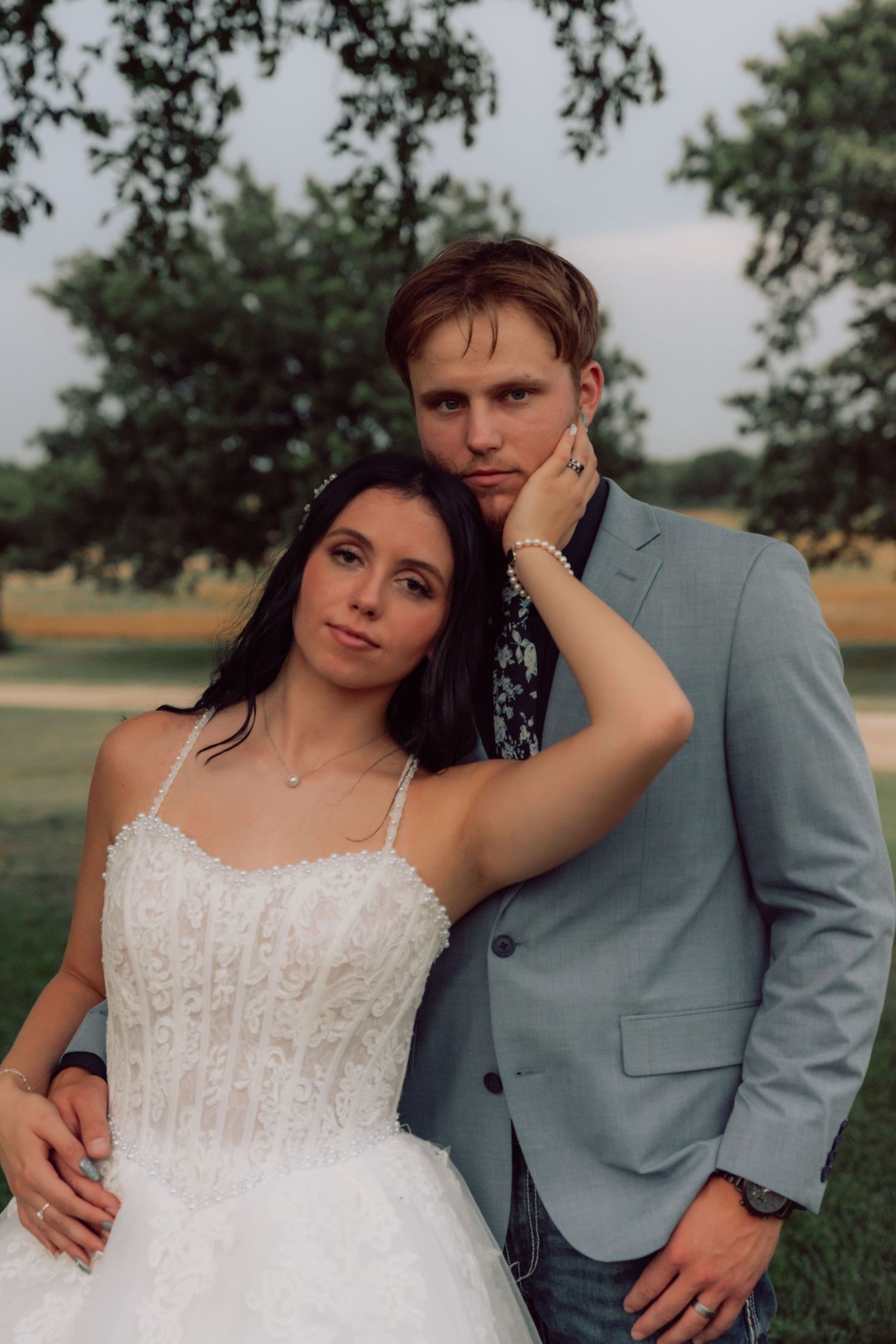 Artistic wedding portraits showcase intimate moments between newlyweds in a natural setting.