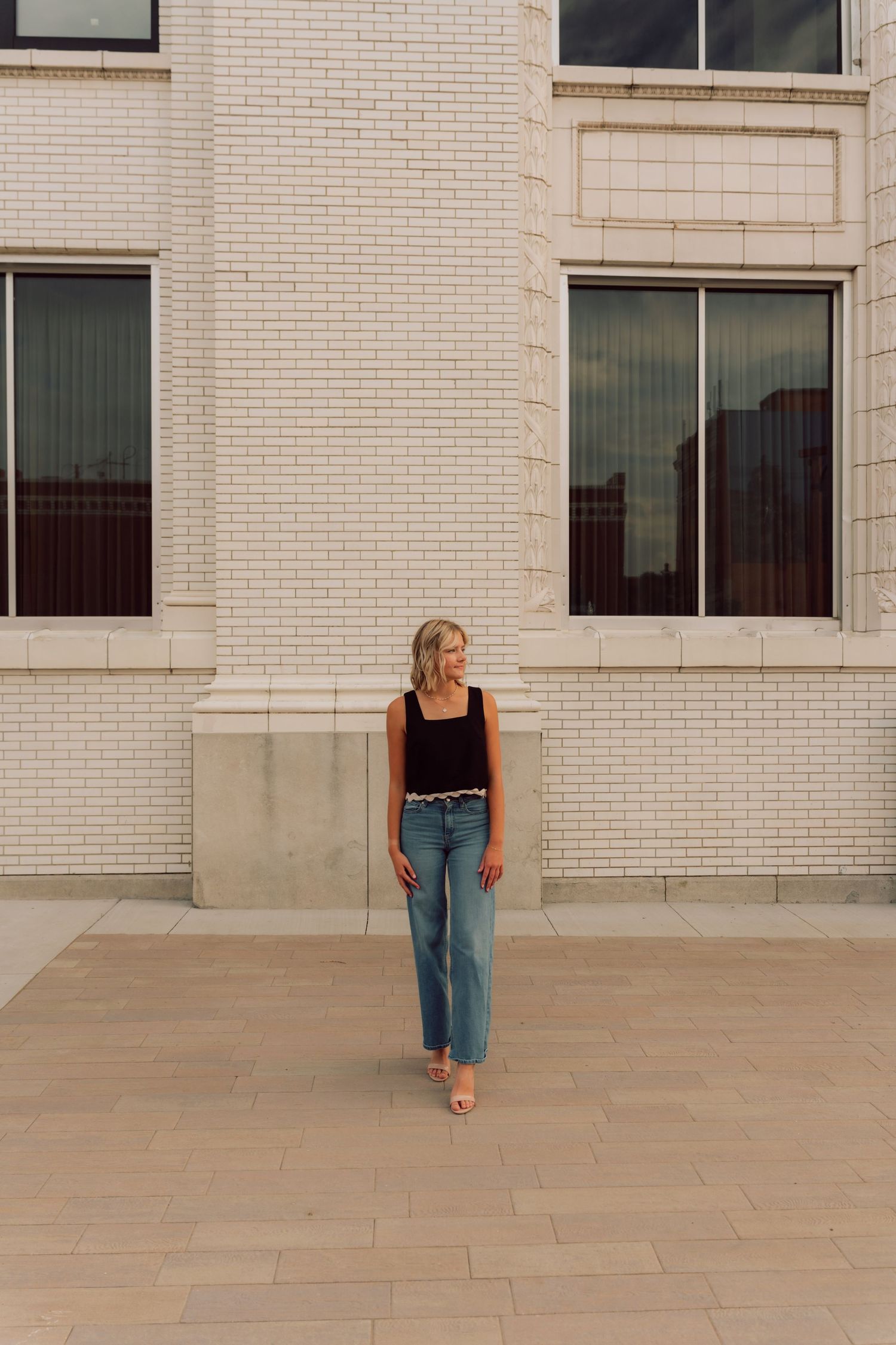 Dynamic movement sequence captured along a modern building's concrete walkway.