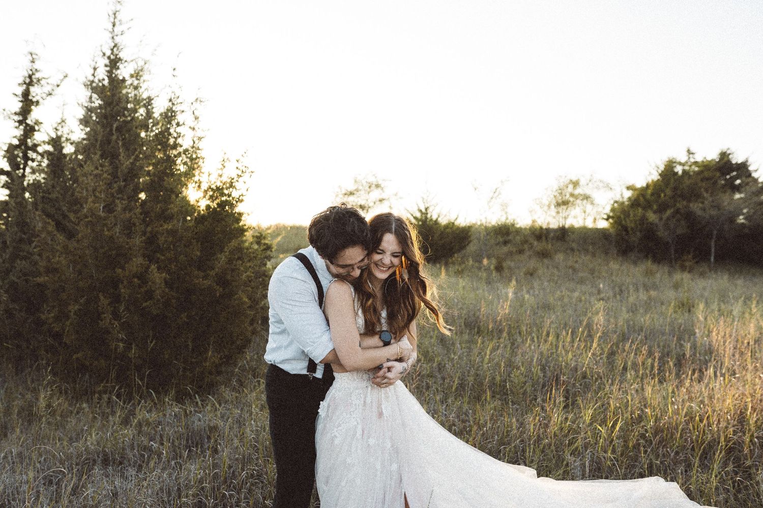 Elegant wedding photography in rustic outdoor setting with dramatic lighting.