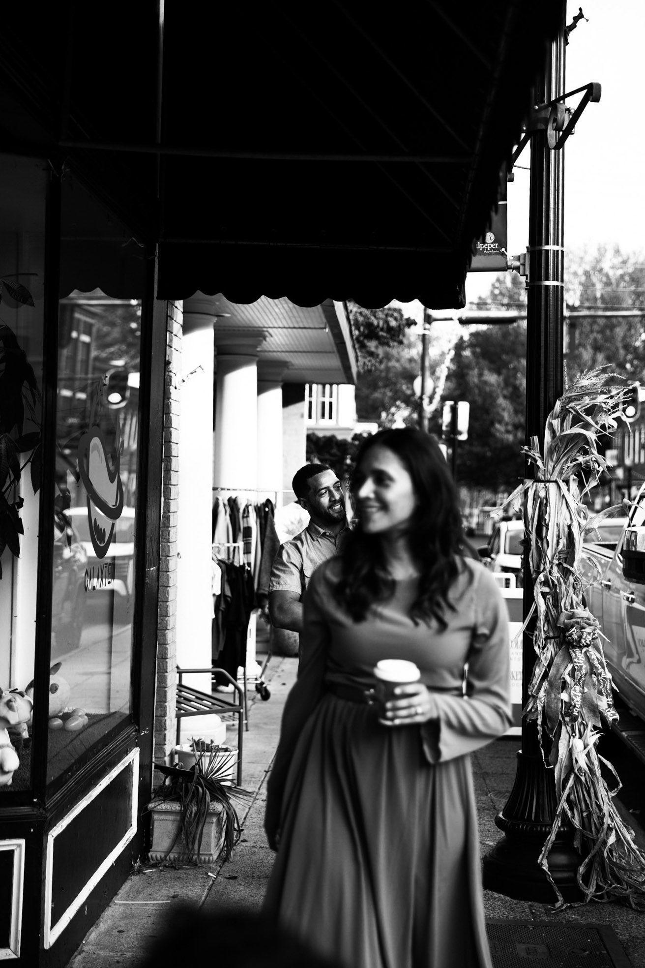 Film style black and white photo of mom walking with family