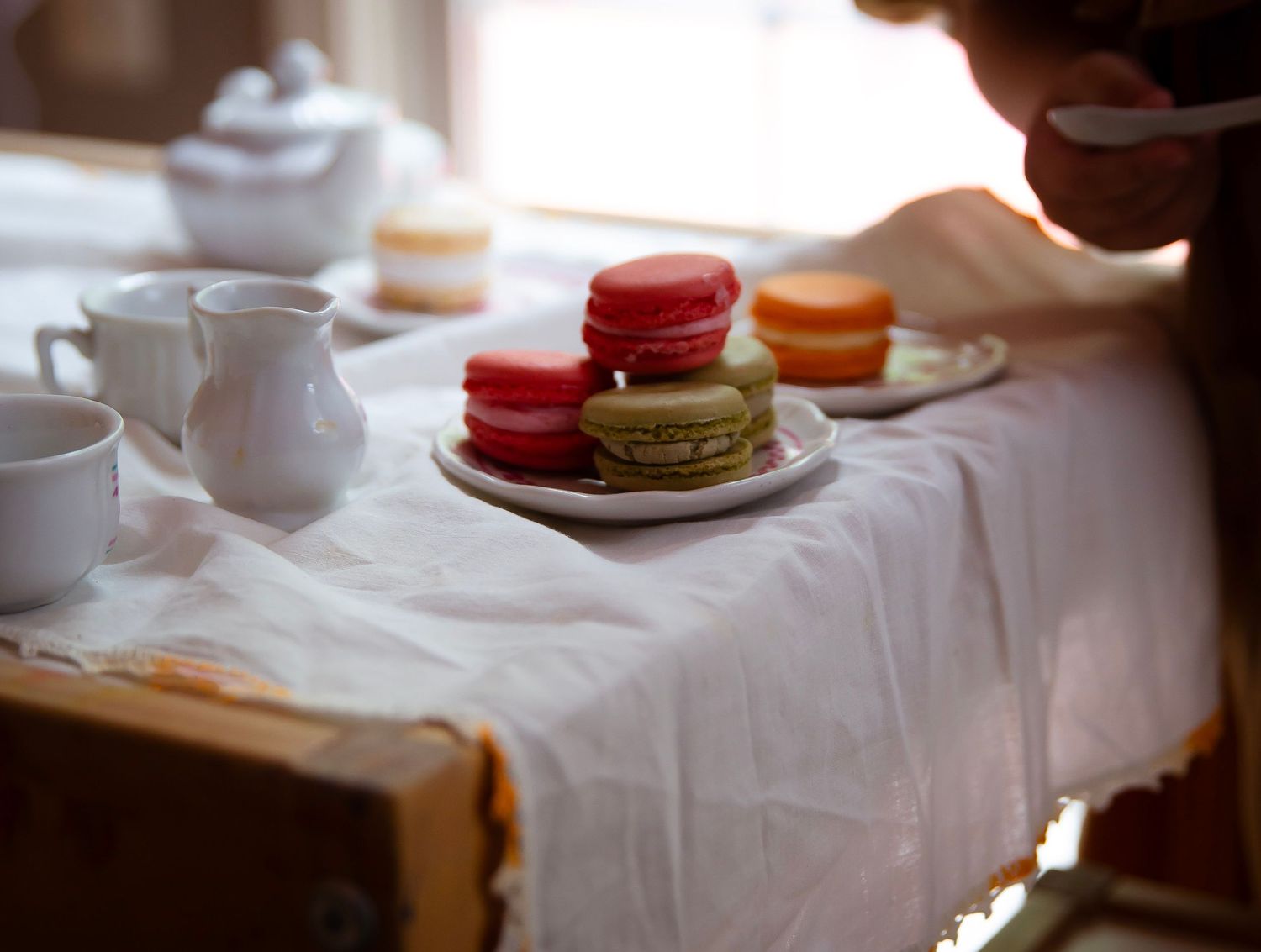 Toddler girl with play tea set