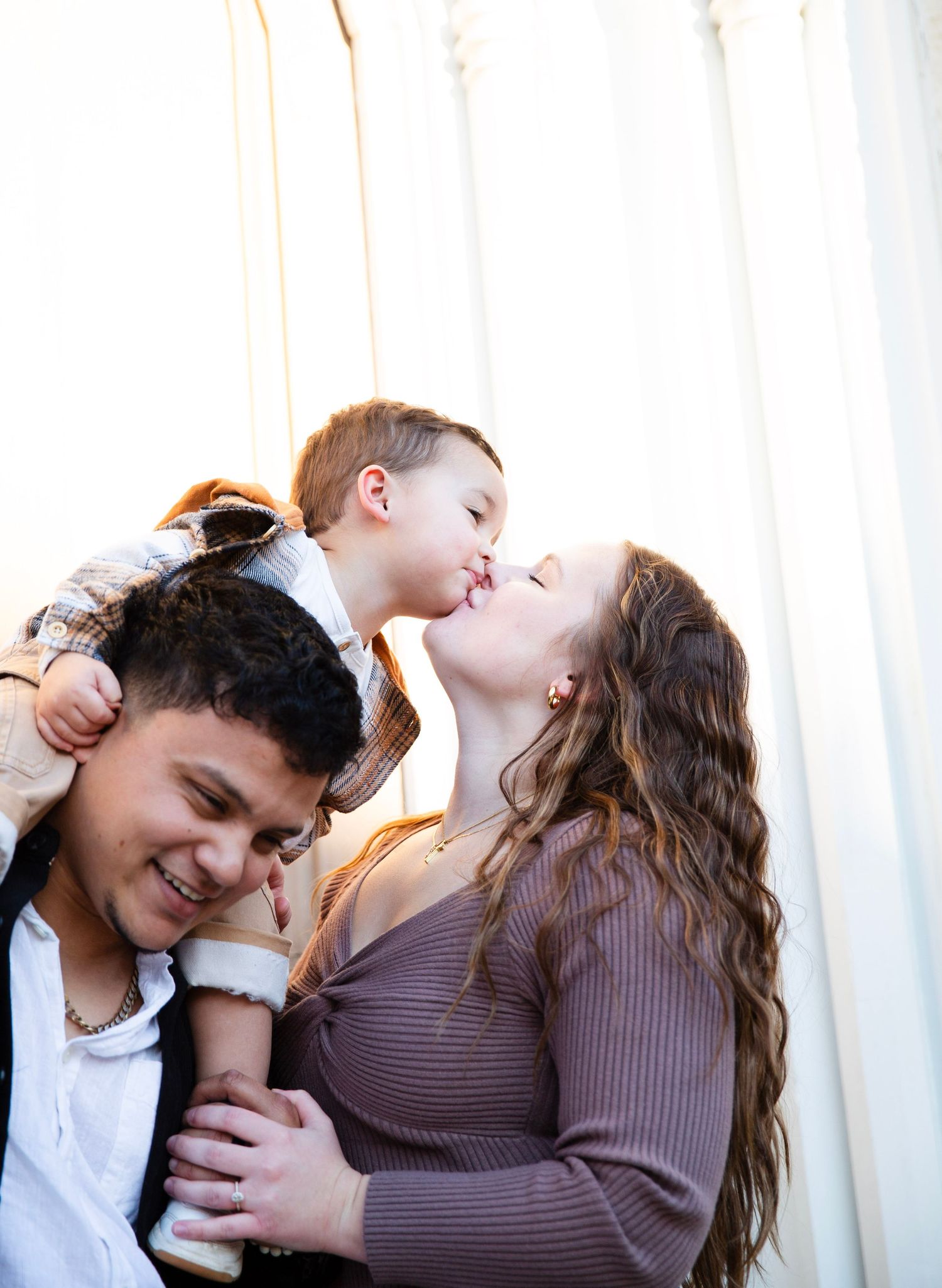 Family  of three sharing a moment in golden hour