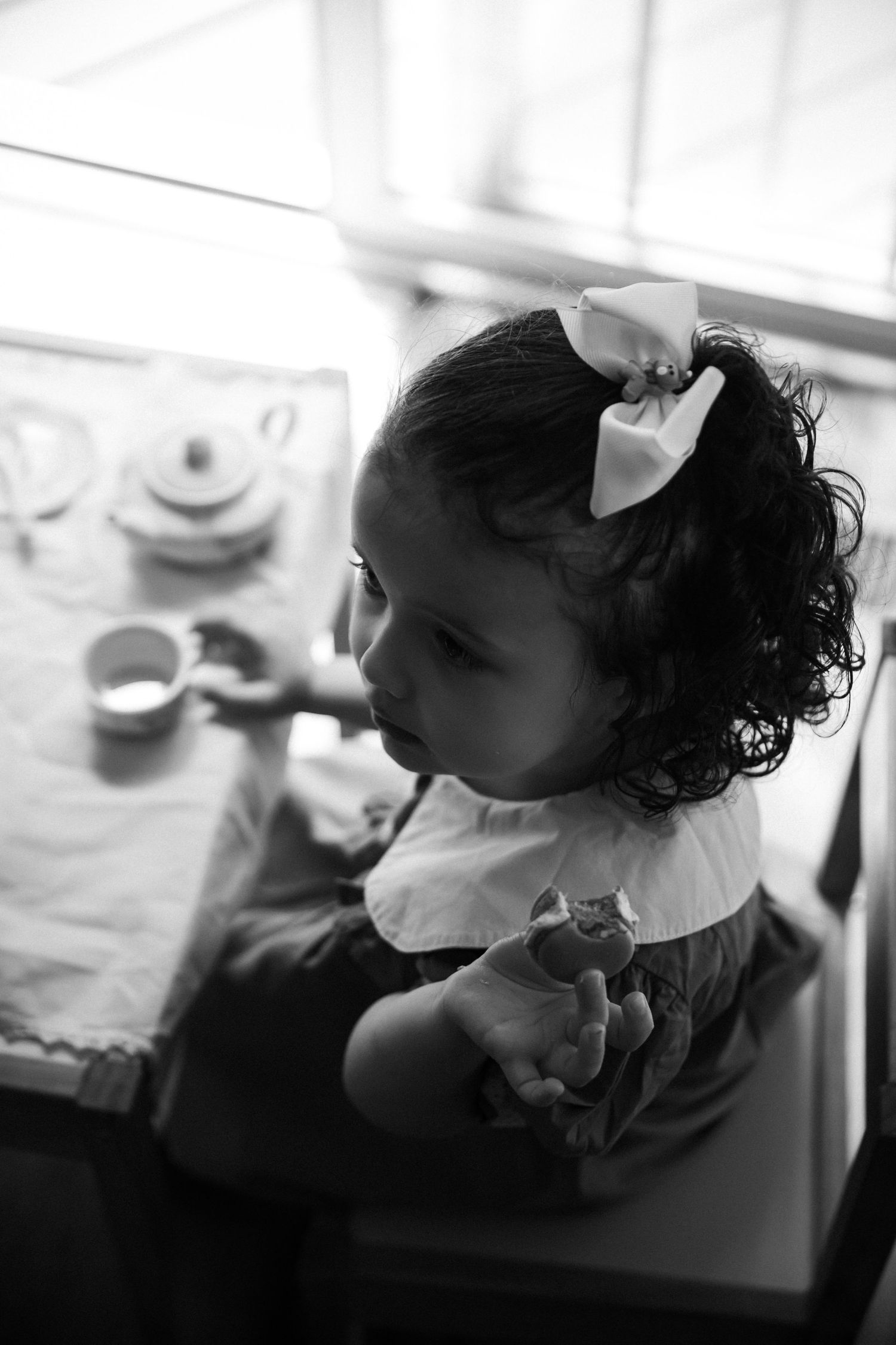 Nostalgic photo of toddler girl at mini table set