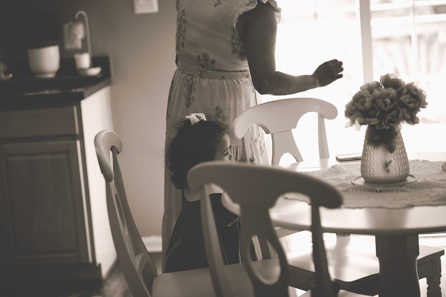 Scene of a table with mom and little girl