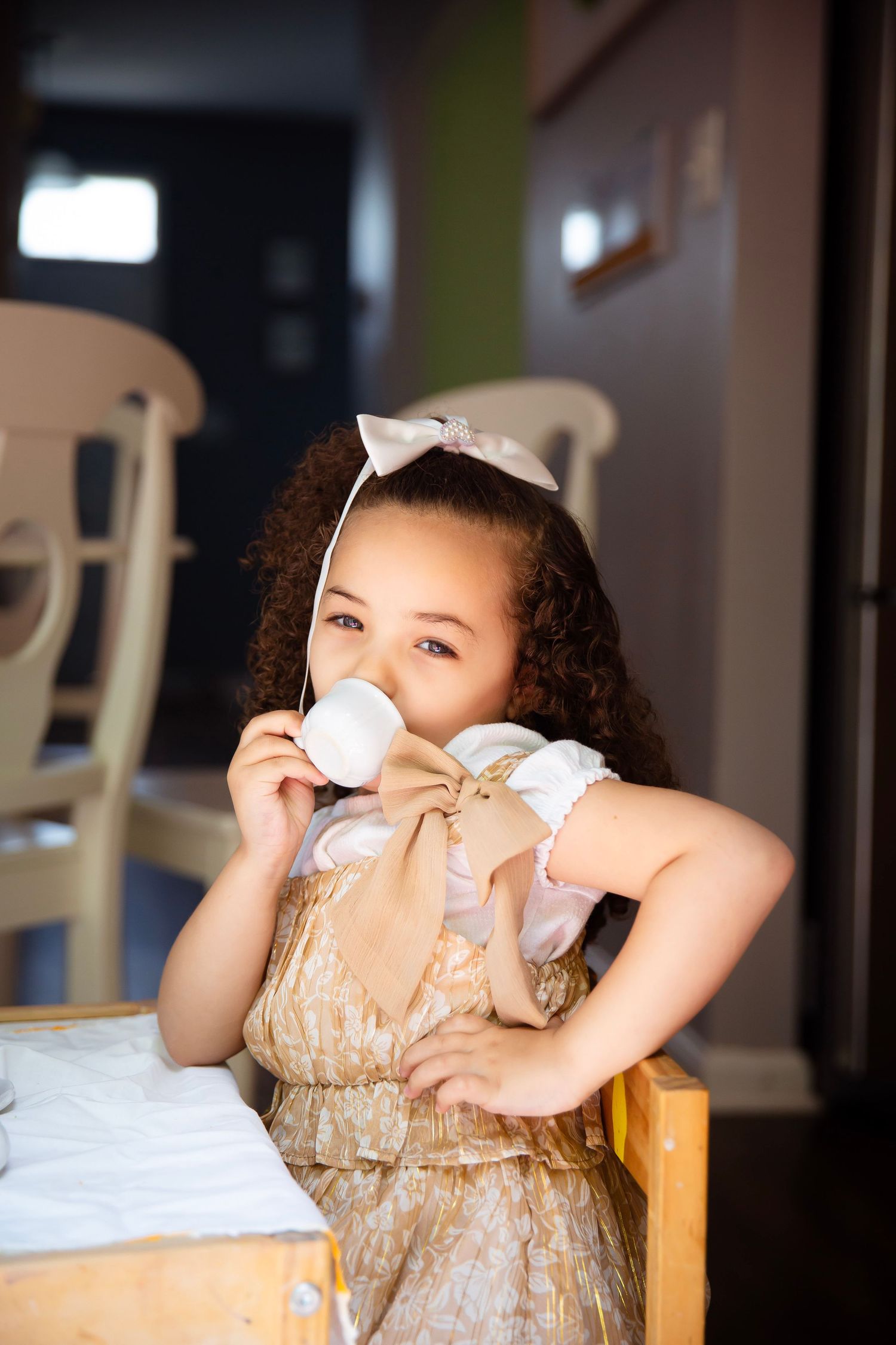 toddler girl with play tea set