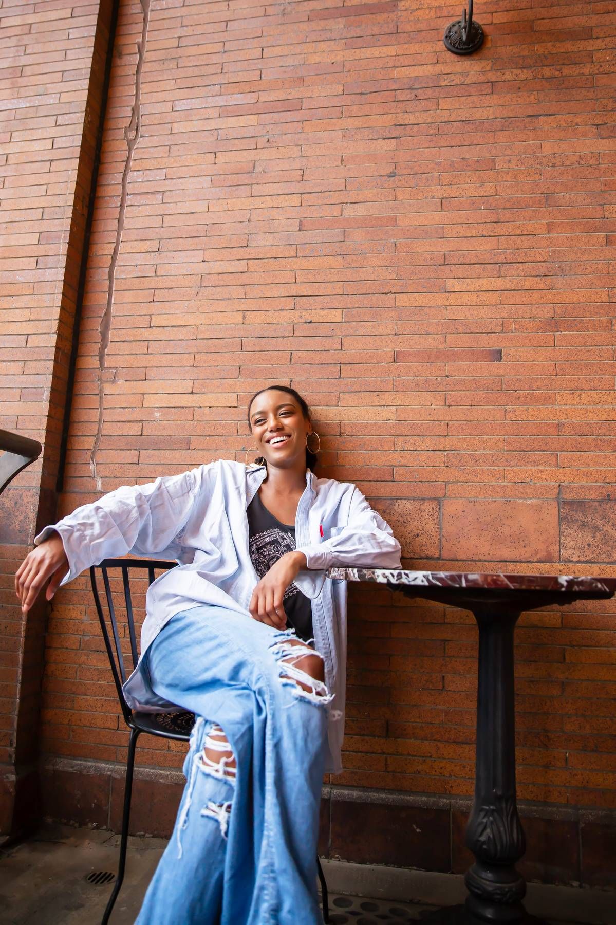 Female model sitting with legs casually crossed