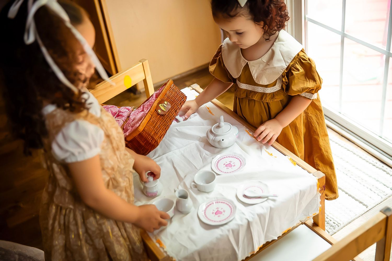 Sisters with play tea set