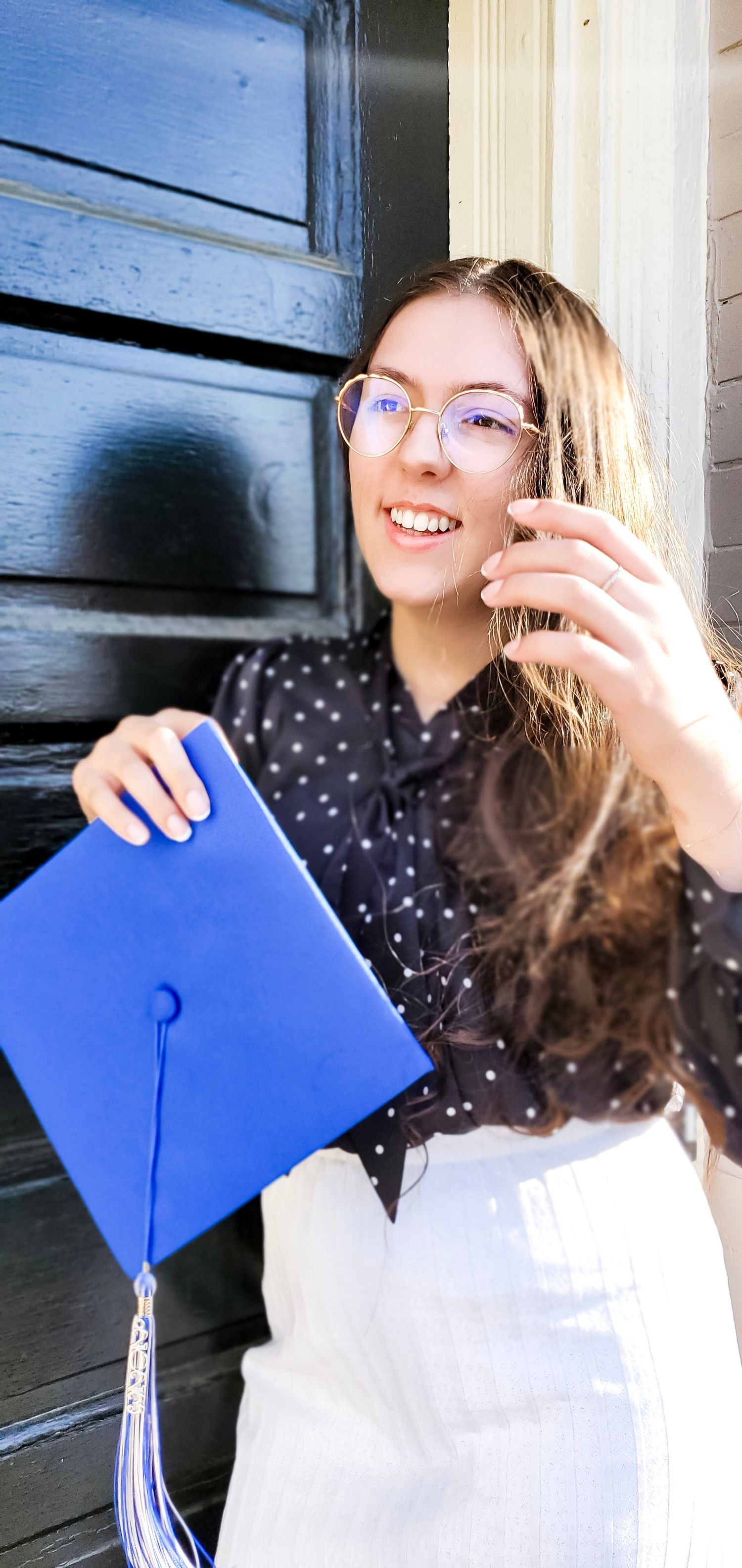 Female graduate in natural pose