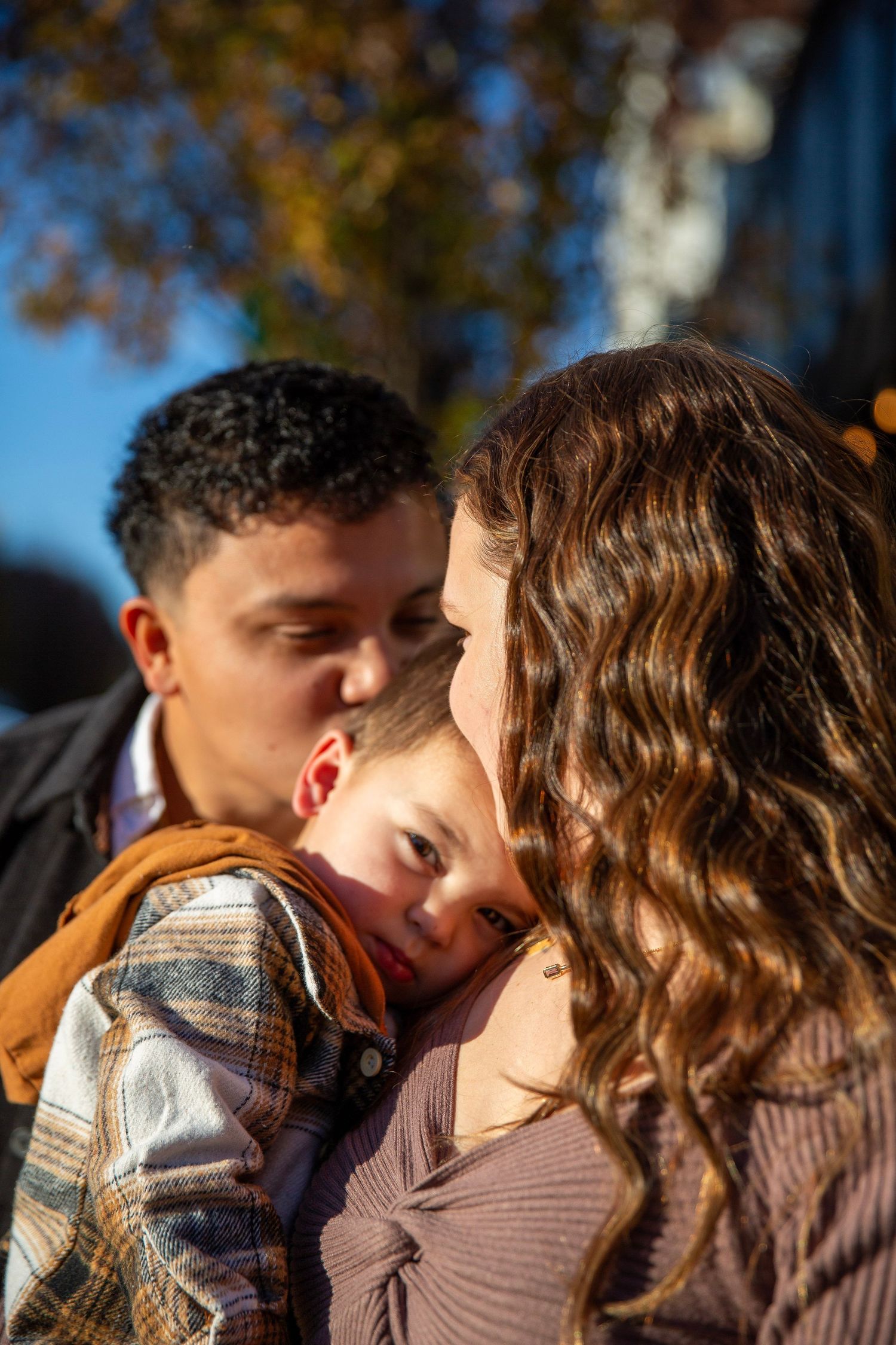 Family  of three sharing a moment in golden hour