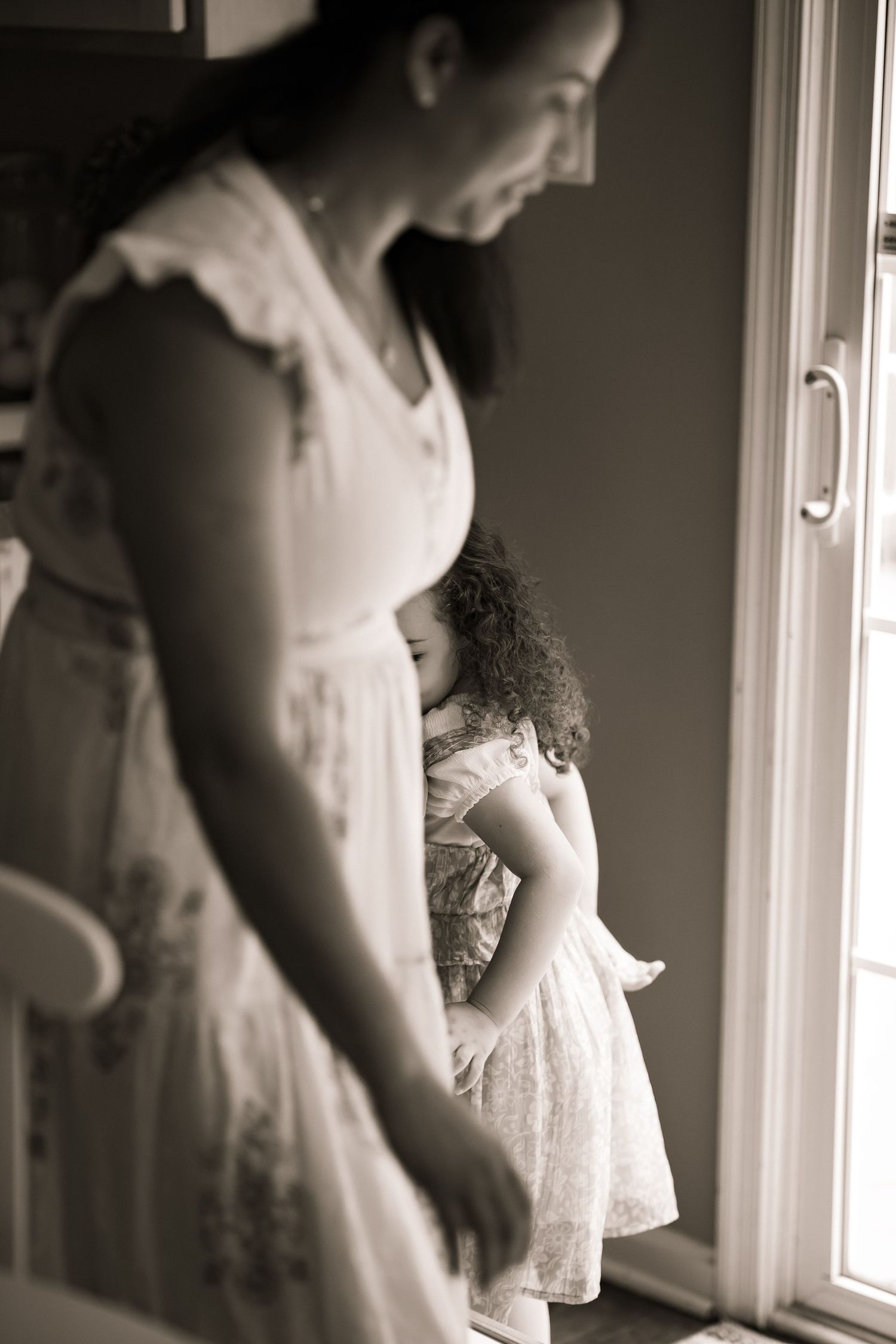 Mom playing with daughter at home.