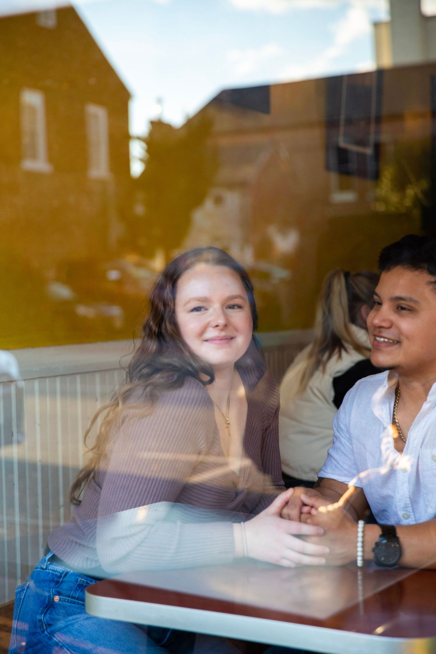 Couple smiling through the cafe window